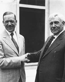 Senator Charles McNary (left) and Representative Gilbert Haugen shake hands after President Hoover signed a modified version of the McNary-Haugen Bill, shortly after succeeding Coolidge in the oval office. THE LIBRARY OF CONGRESS.