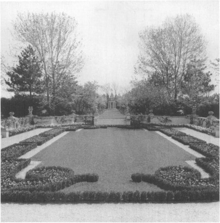 Formal garden design with rectangualr middle with small shrub borders and grass in the center.